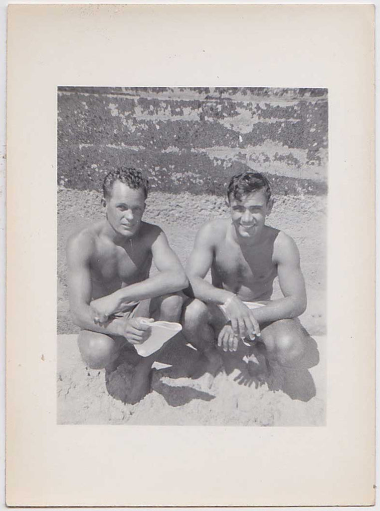 vintage snapshot Two humpy guys pose knee to knee on Waikiki. Identified on verso.