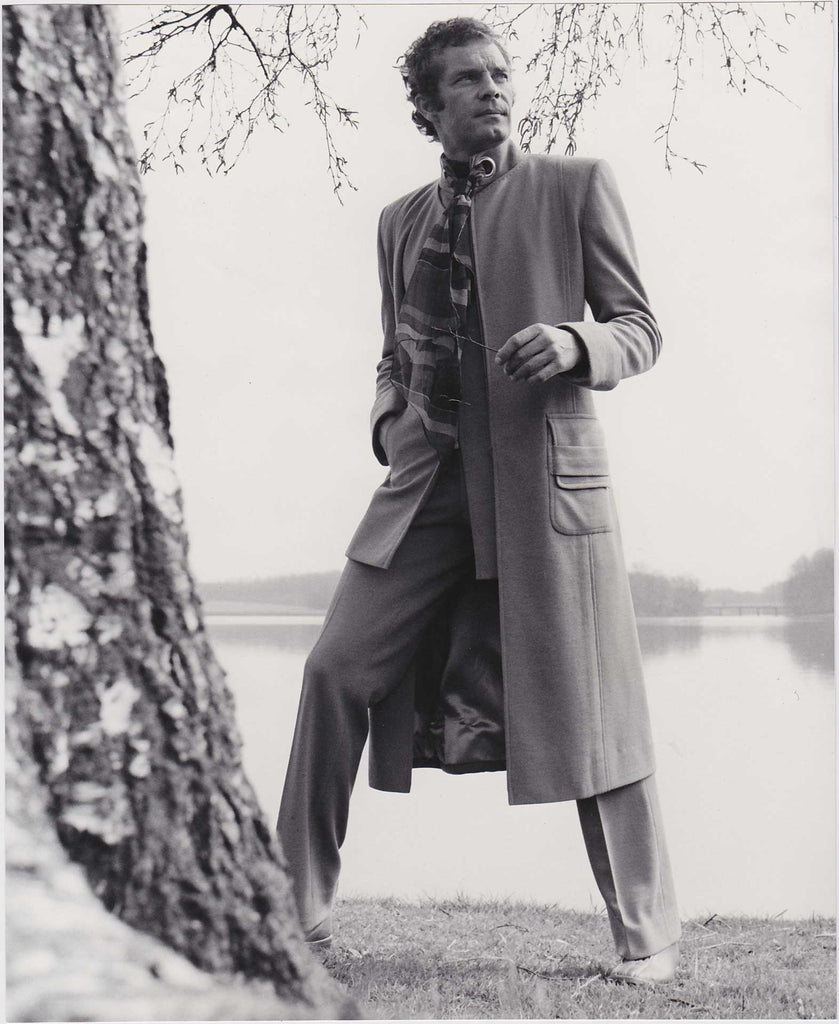 Vintage Men's Fashion photo c. 1972.  Designer: Gloria Gross, London.  Suit and matching collarless overcoat in a greige double jersey twill of 100% Dacron