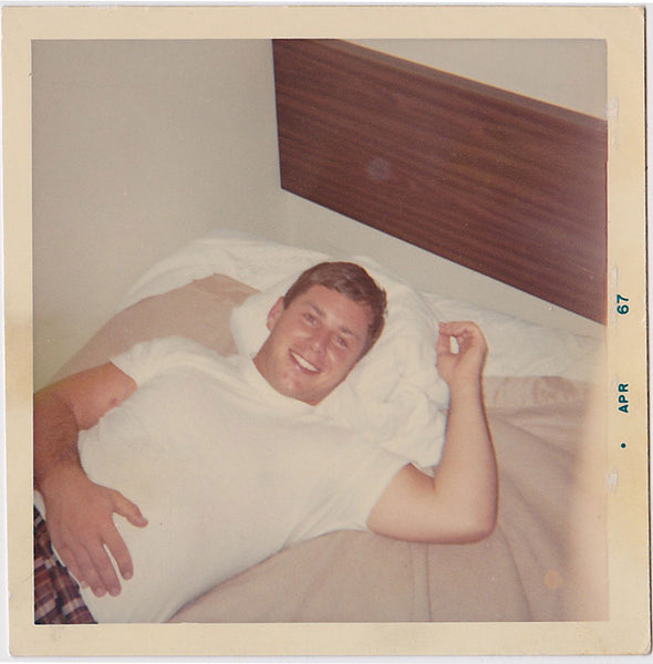 Smiling Guy on Bed vintage color snapshot April 1967