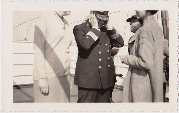 He has a smile on his face but the captain of this ship has heard more than enough from the three women vintage snapshot