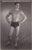 Handsome, lightly oiled athlete poses in the studio vintage real photo postcard