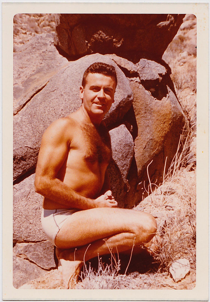 Hairy Chested Man Posing by Boulders