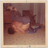 Shirtless young guys wrestle on living room floor vintage color photo