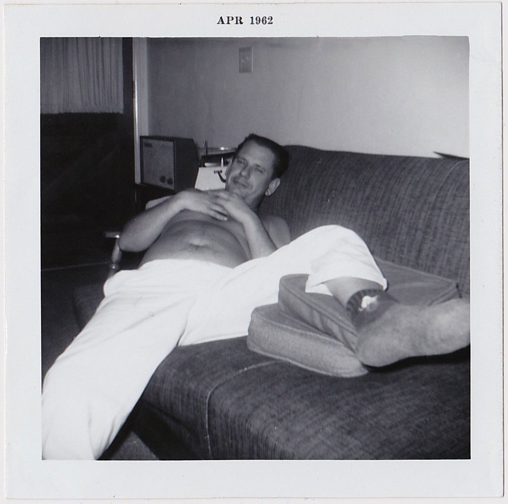 man resting on sofa vintage photo