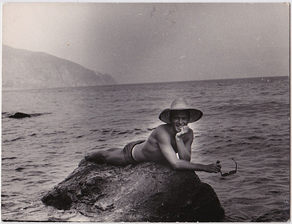Handsome guy reclines on a rock like a merman.  Vintage photo gloss finish on heavyweight paper, undated 1960.
