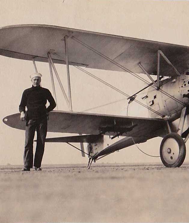 Dashing Navy Flyer Standing Beside Corsair – Homobilia