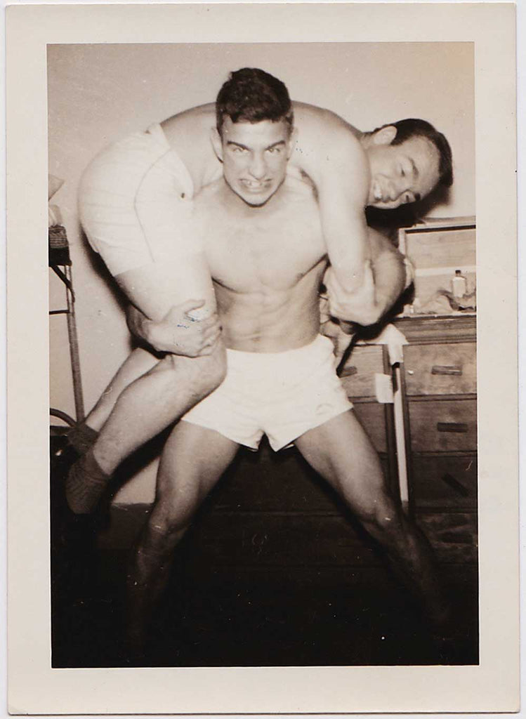 Lot of two vintage photos shows guys in their shorts wrestling and mugging for the camera