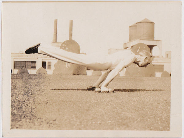 Anonymous vintage photo of a hand balancer working out on a rooftop.