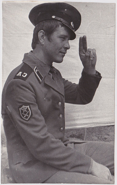 Vintage photo Handsome Russian soldier seen in profile, offering a relaxed salute.