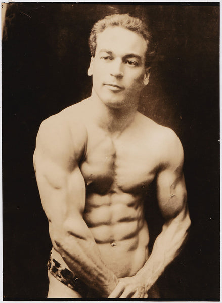 Handsome muscular strongman identified on verso as "Samuel Olmstead" flexes in his skimpy leopard-skin posing trunks.
