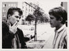 A tense moment between two guys standing on a dreary Berlin street. vintage gay photo