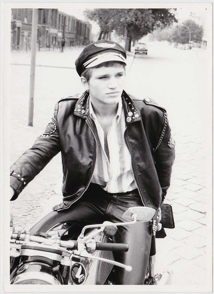 Handsome young leather man on a nearly abandoned Berlin street. vintage gay photo