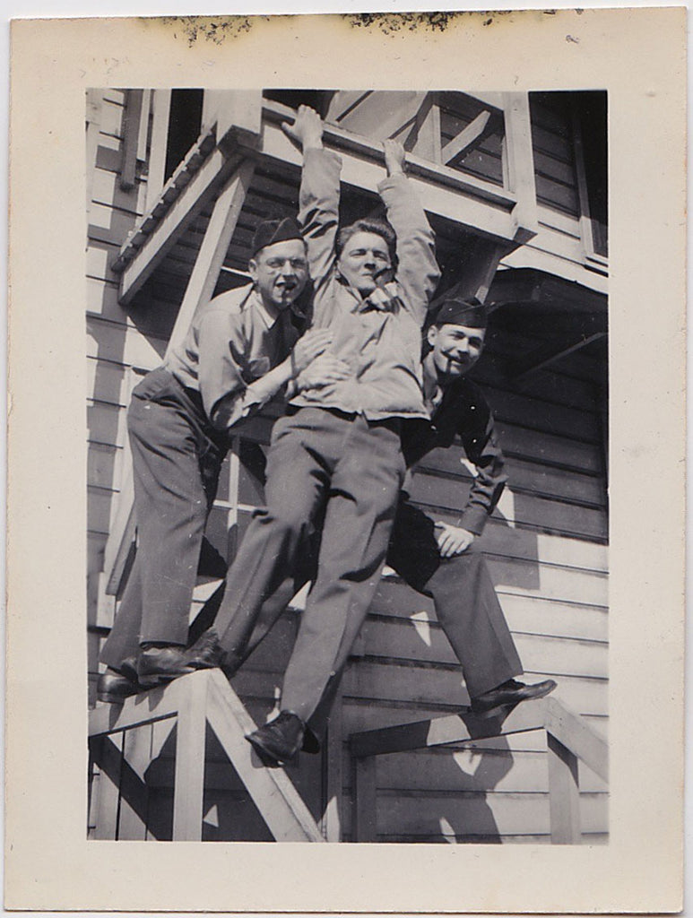 Vintage snapshot of three soldiers hanging around, smoking cigars, having fun.