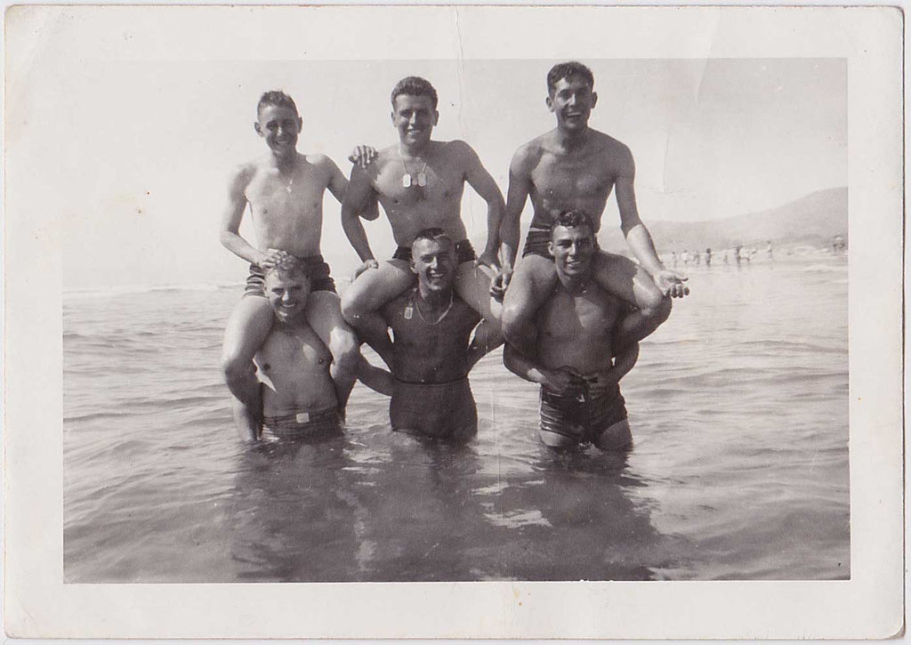 GIs standing in the ocean with their buddies hoisted on their shoulders vintage snapshot