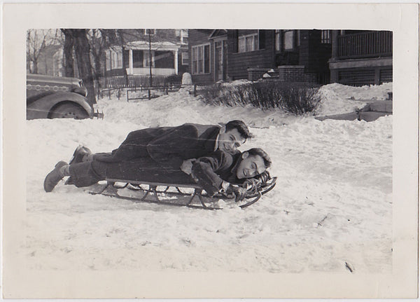 Two men share a sled. They don't seem to be going anywhere vintage snapshot 1950s.