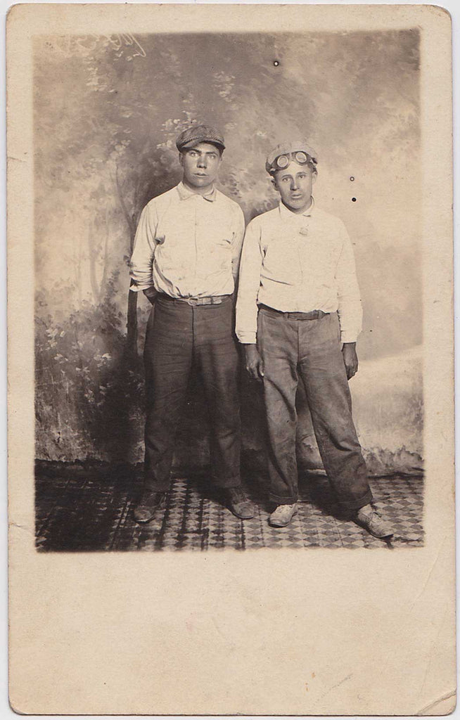Two men  they seem innocent or bemused, vintage real photo postcard