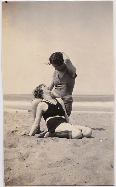 Two women strike a romantic pose on the beach vintage photo