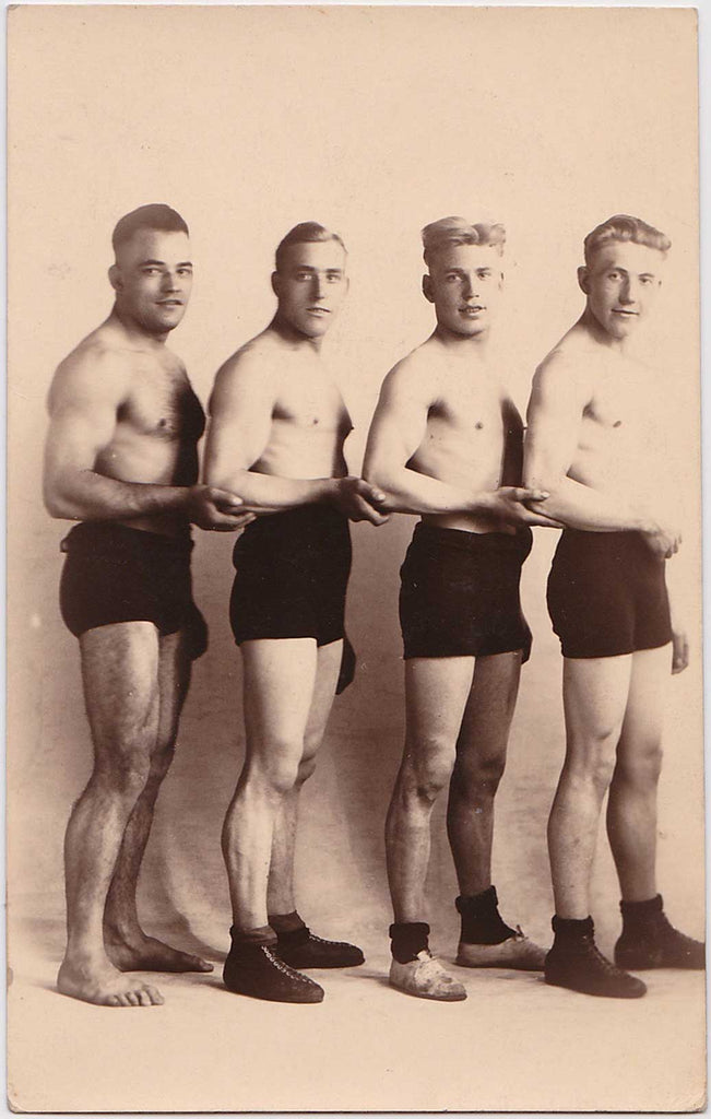 Vintage sepia Real Photo Postcard of a wrestling team. 